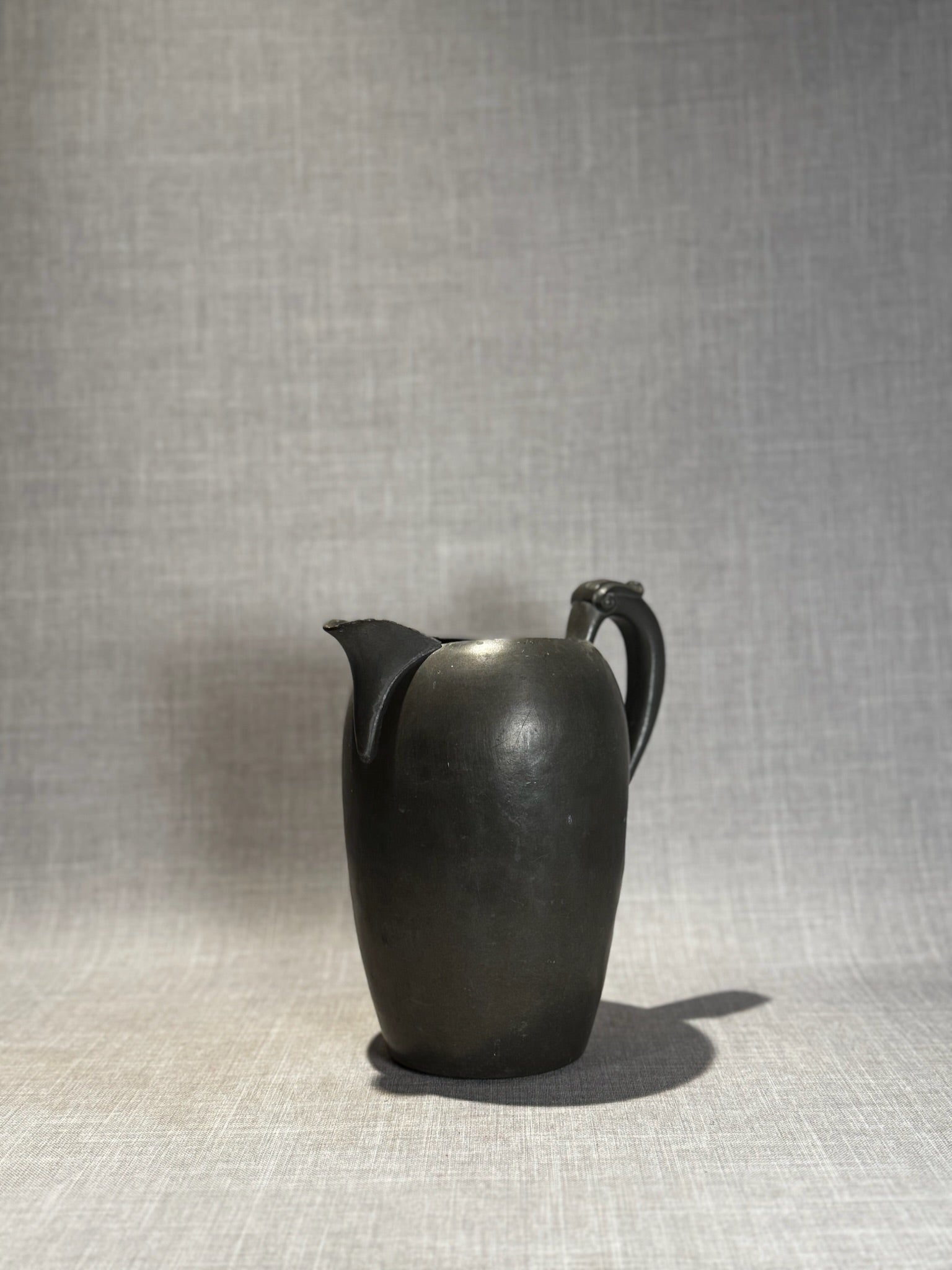 Vintage Black Ceramic Pitcher with Sculpted Scroll Handle – Matte Handcrafted Art Pottery Vessel