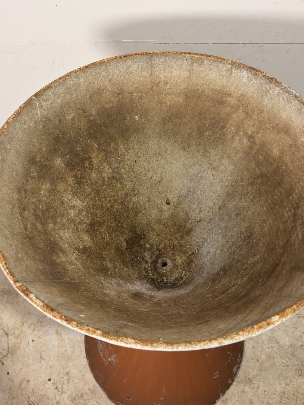 Vintage ceramic bowl with a worn surface on a light background