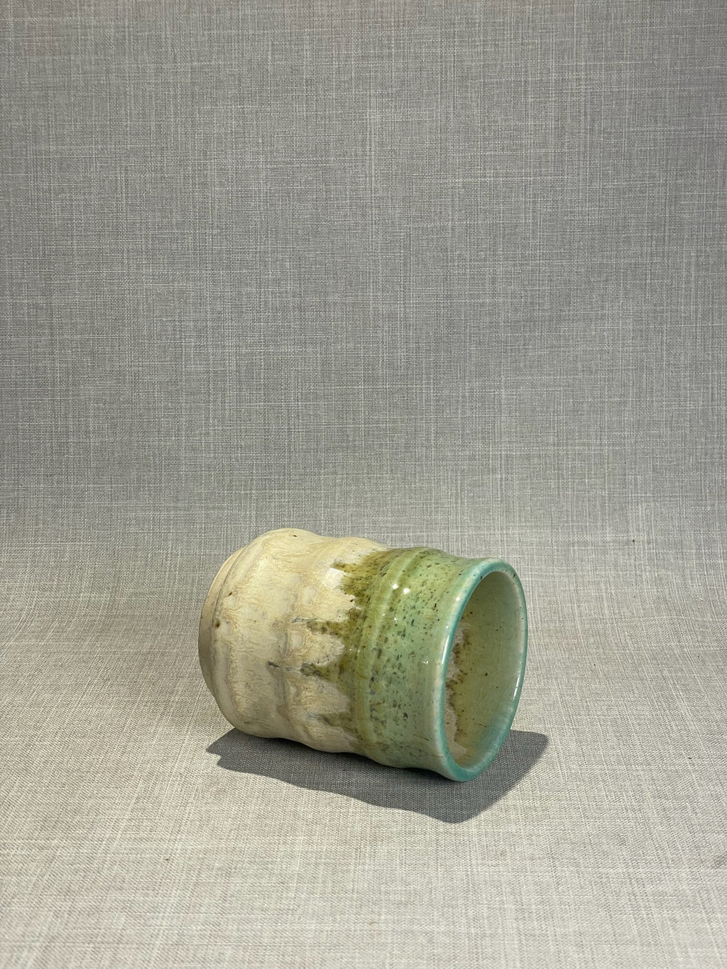 artisan pottery cup with organic drip glaze finish