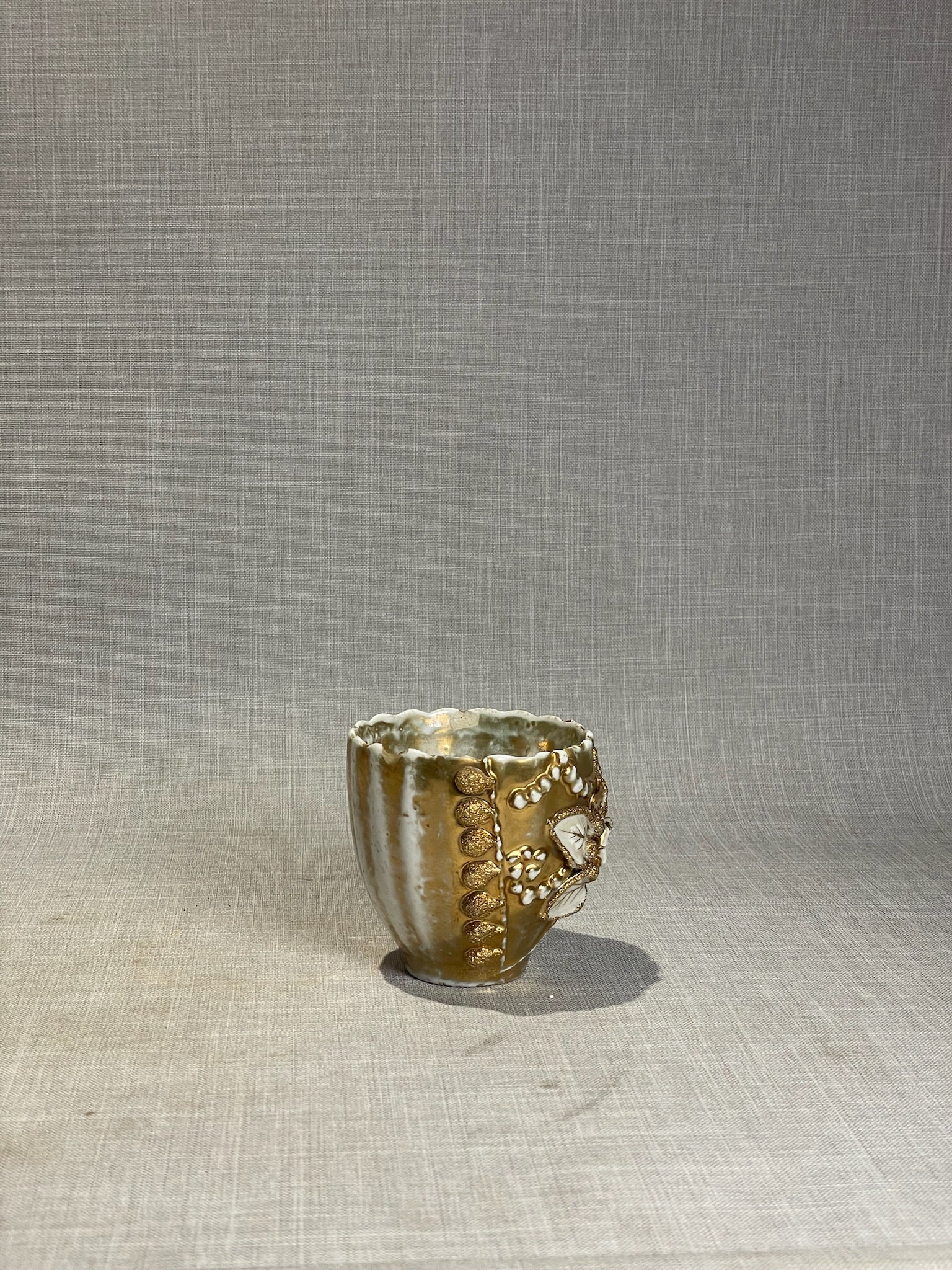 Antique Gilt Porcelain Cup with Applied Floral Medallion