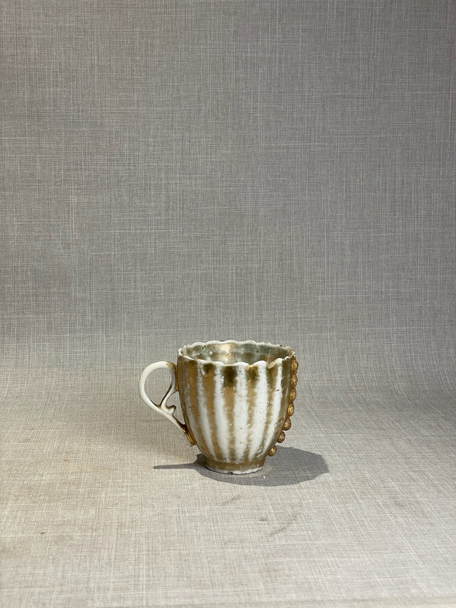 Antique Gilt Porcelain Cup with Applied Floral Medallion