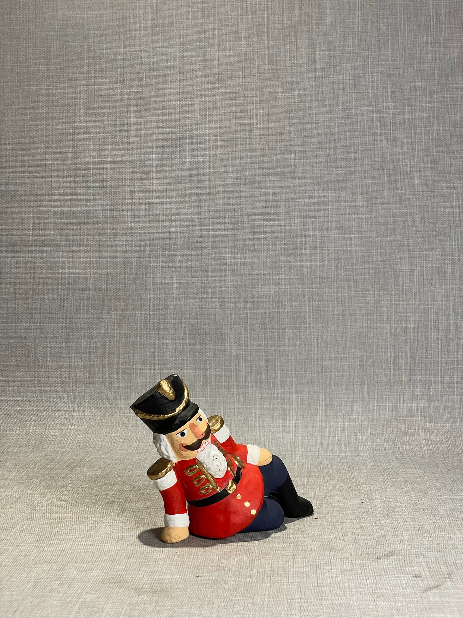 Whimsical Hand-Painted Reclining Nutcracker Soldier Holiday Figurine