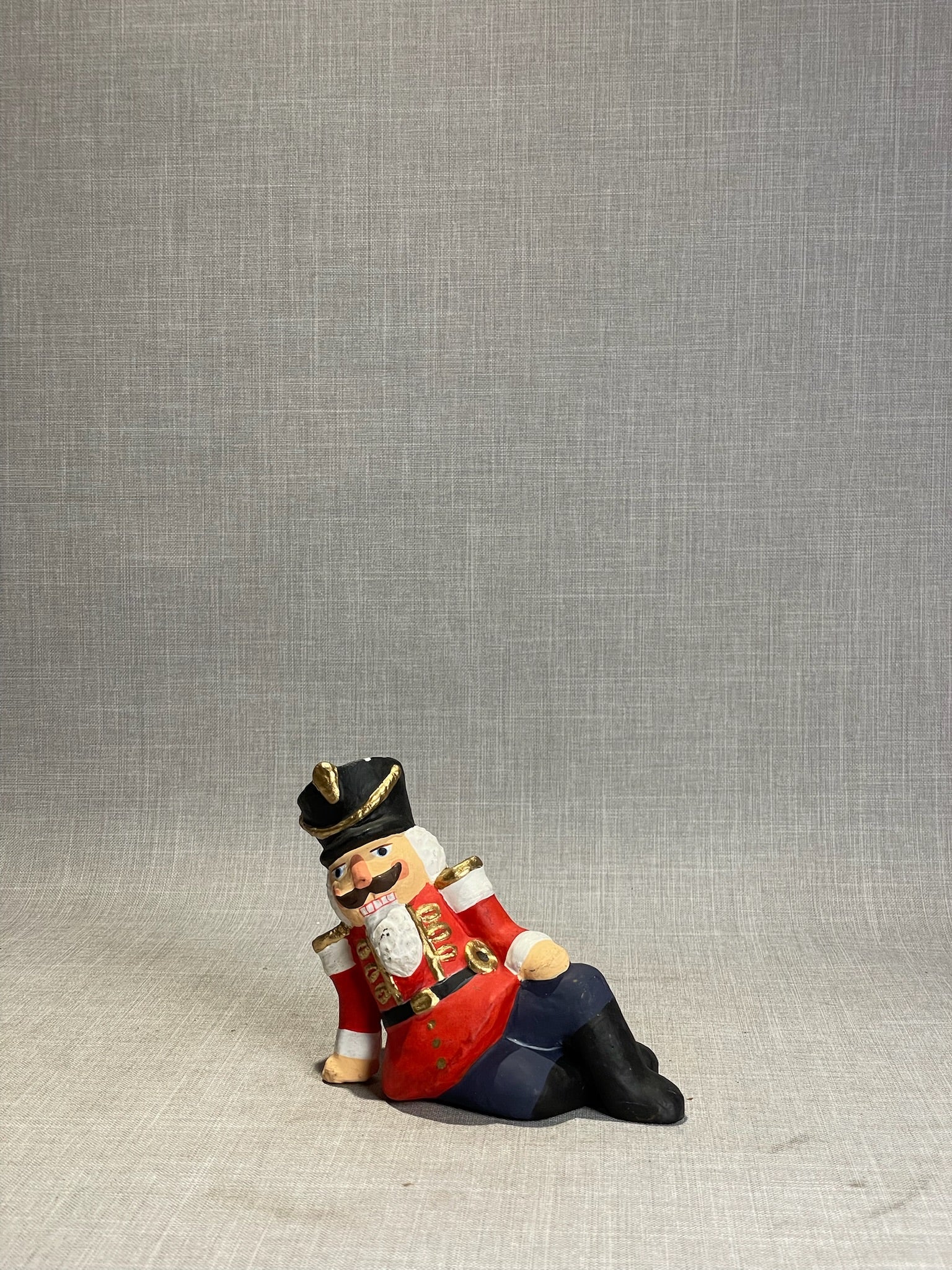 Whimsical Hand-Painted Reclining Nutcracker Soldier Holiday Figurine