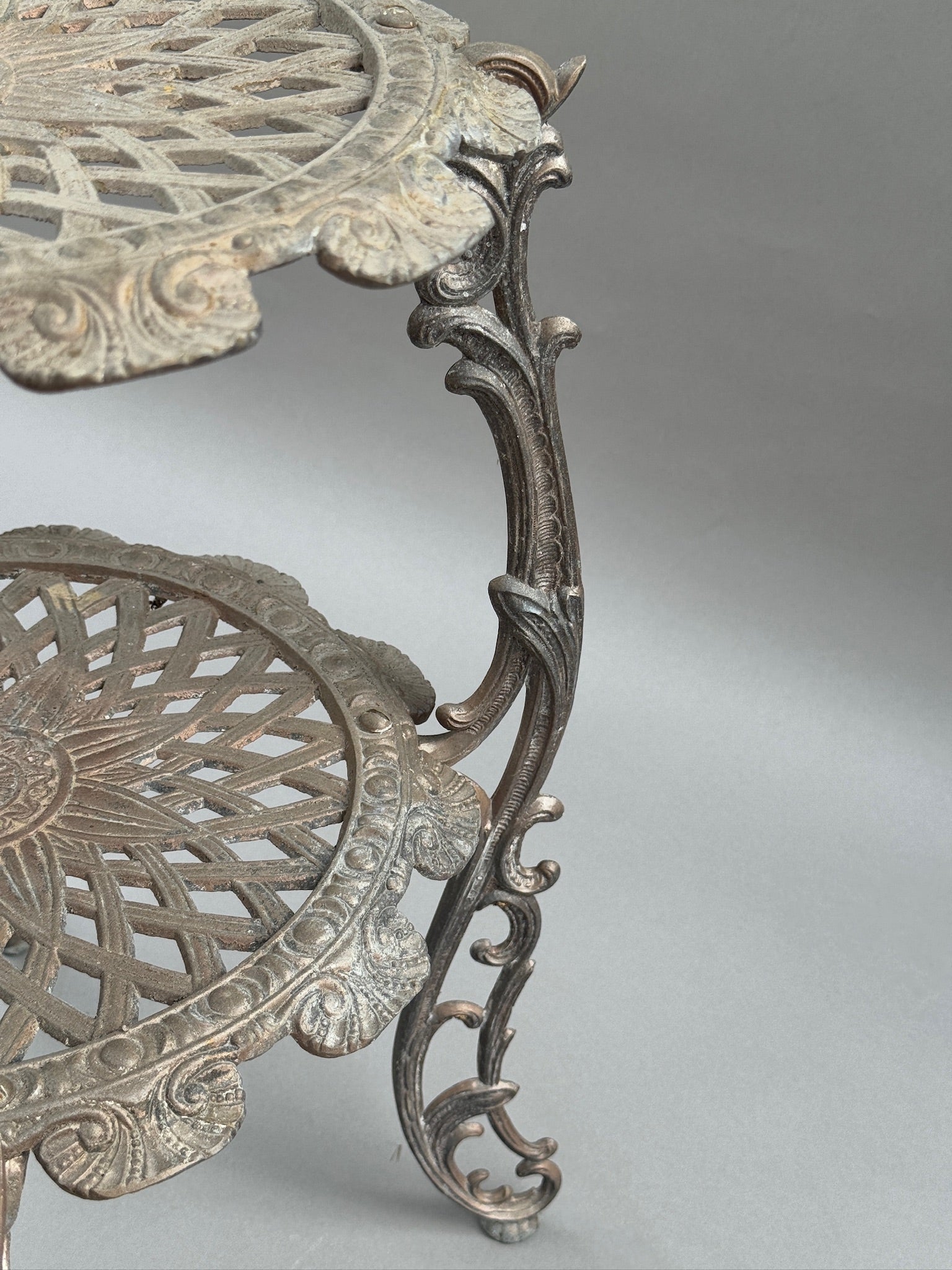 Ornate Victorian Revival Cast Iron Two-Tier Plant Stand with Pierced Floral Design close-up of intricate floral details and scalloped edges. hommes + gardens estudio.
