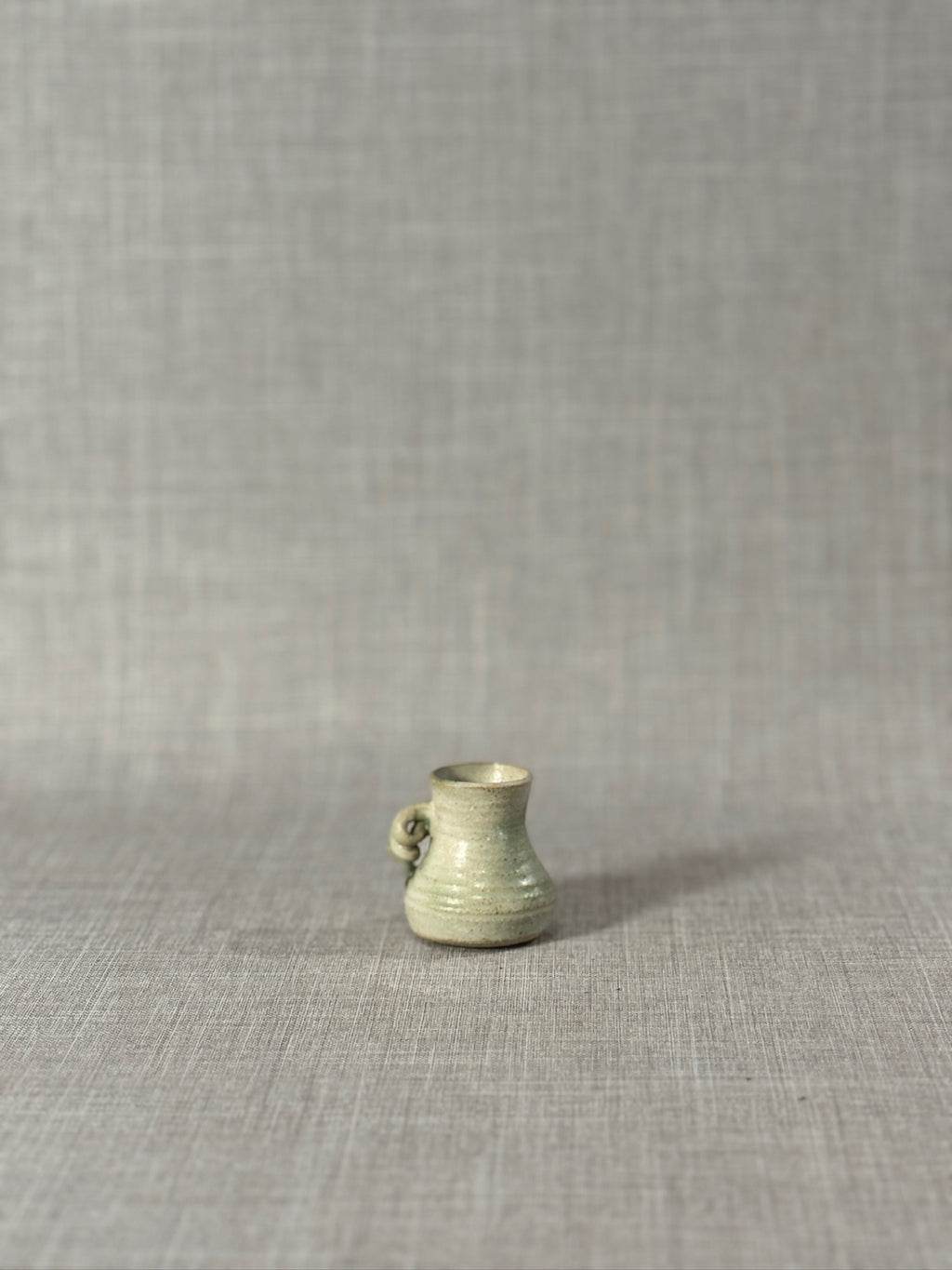 Signed Miniature Studio Pottery Jug – Hand-Thrown Celadon Green Stoneware Vessel with Sculptural Handle