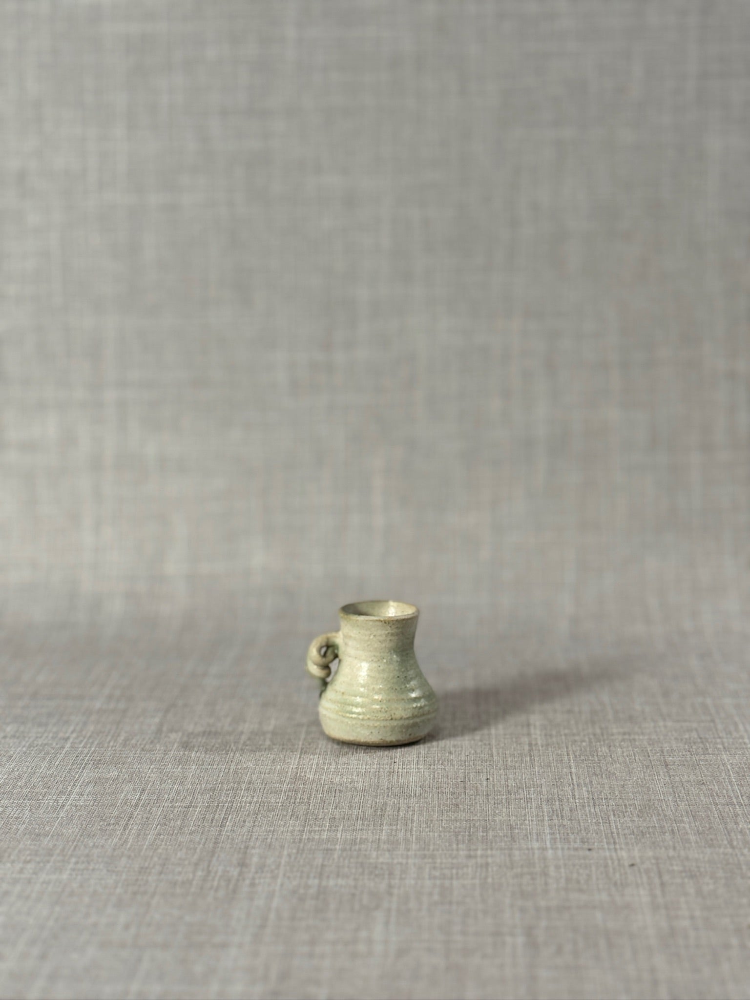 Signed Miniature Studio Pottery Jug – Hand-Thrown Celadon Green Stoneware Vessel with Sculptural Handle