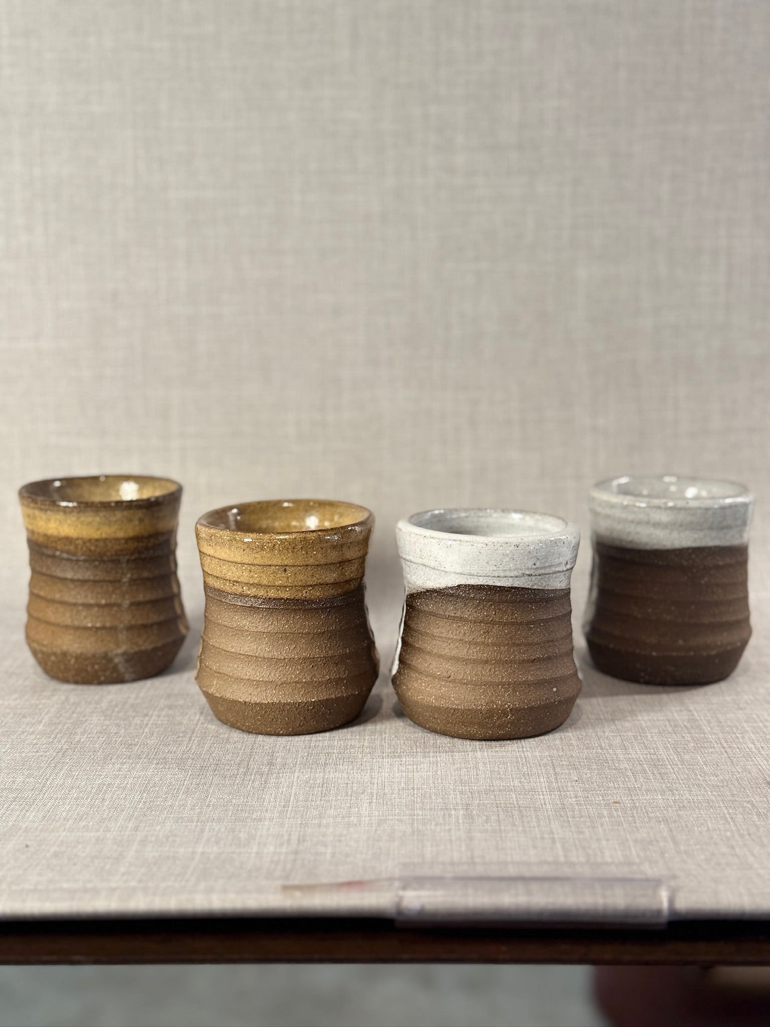 Set of Four Artisan Wheel-Thrown Stoneware Mugs with Earthy Brown and Ash Glaze Finish