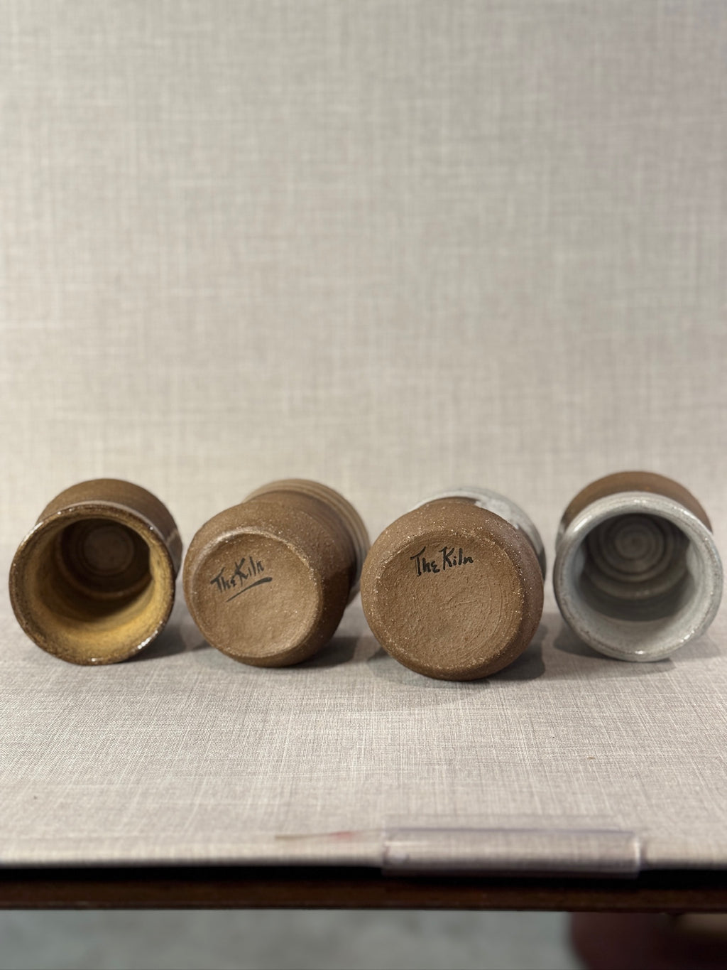 Set of Four Artisan Wheel-Thrown Stoneware Mugs with Earthy Brown and Ash Glaze Finish