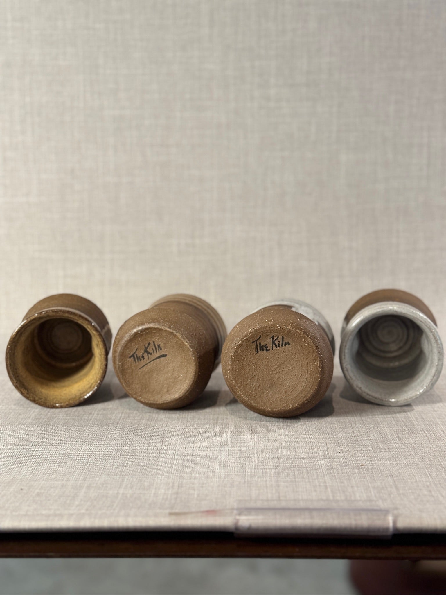 Set of Four Artisan Wheel-Thrown Stoneware Mugs with Earthy Brown and Ash Glaze Finish