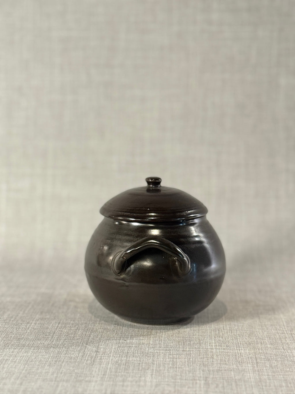 Mid-Century Black Glazed Studio Pottery Bean Pot with Lid and Sculpted Handles