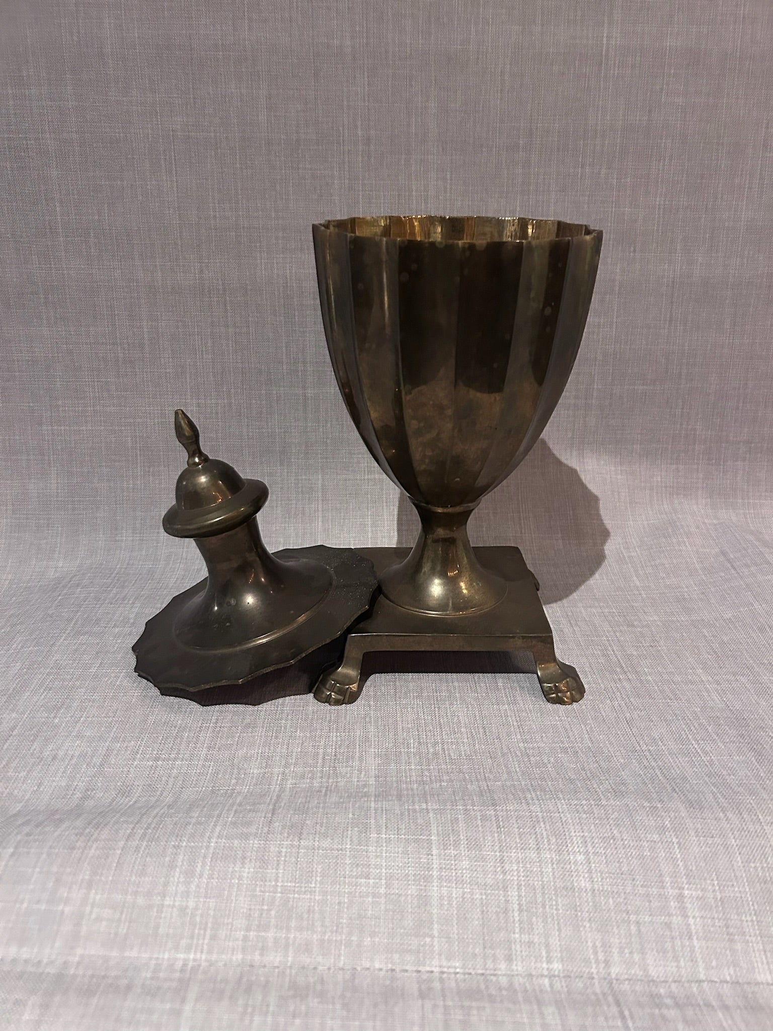 Monumental Antique Brass Lidded Urn with Fluted Body, Turned Finial and Sculptural Paw Feet on Square Plinth Base