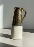 large terracotta pitcher with half gold glaze and textured white body