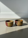 pair of mid century studio pottery bowls with oxblood and ochre glaze
