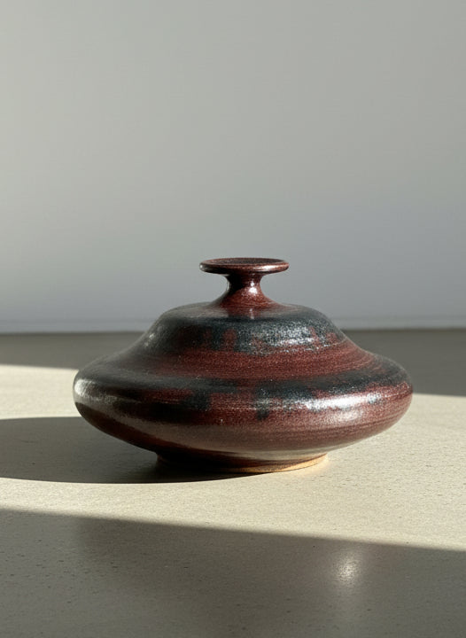 Brown ceramic pot on a textured gray background