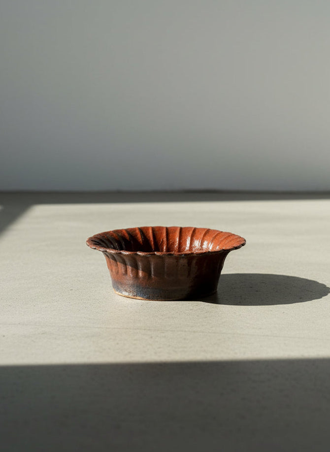 antique style dark red earthenware bowl with scalloped rim
