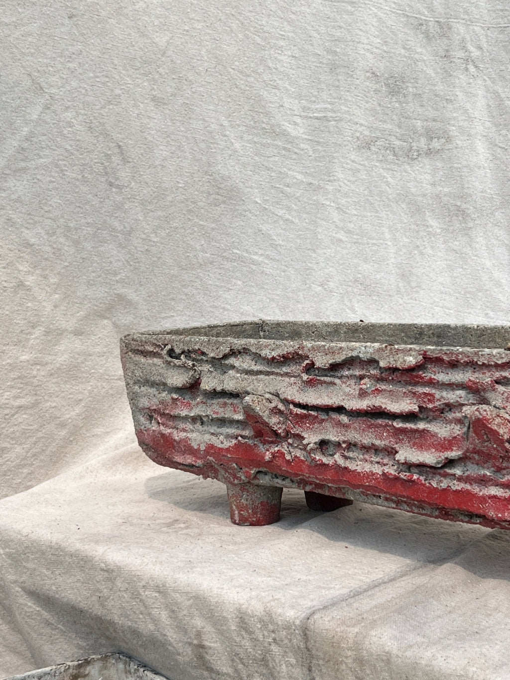 1960s French faux bois trough concrete planter with red paint patina, handcrafted to mimic natural wood texture, a striking vintage garden accent — Hommes and Gardens, Pots + Planters Collection, Landscape Architect, Interior Designer, Outdoor Living, Art, Furniture, Objects, Best Gifts, Nature, Backyard, Yard, Outdoor Decorations, Home Decor, Home Design, Luxury Design.