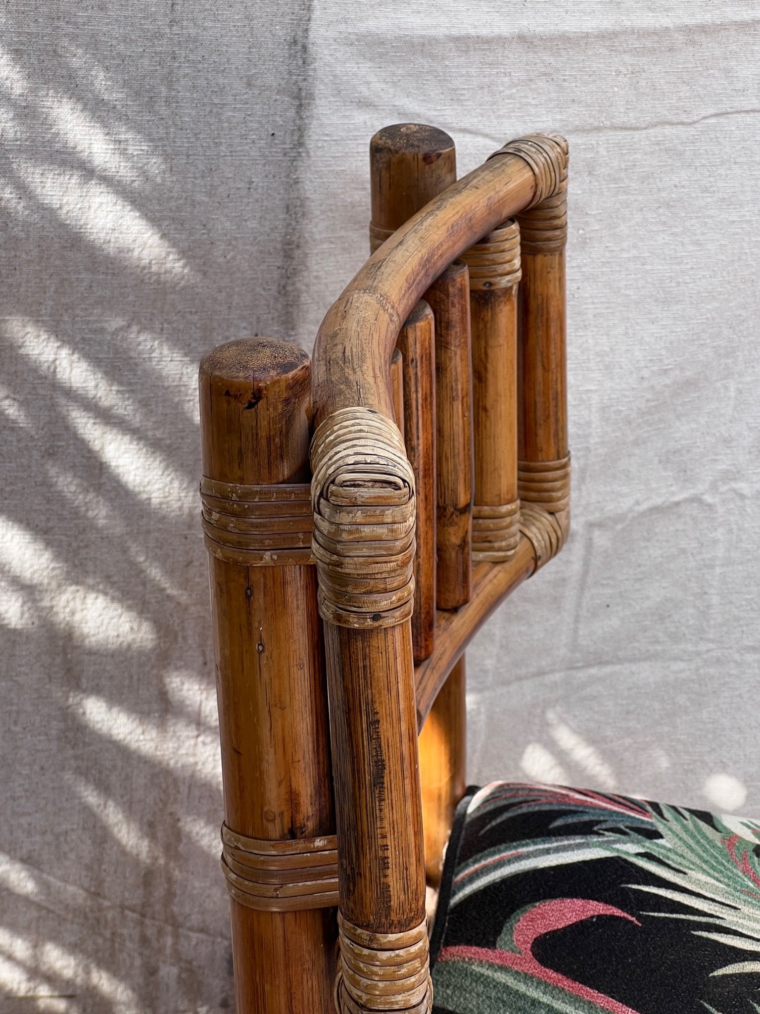 Rattan Bistro Table with Black Glass Top chair detail featuring vintage bamboo design and Hollywood Palm upholstery, hommes + gardens estudio.