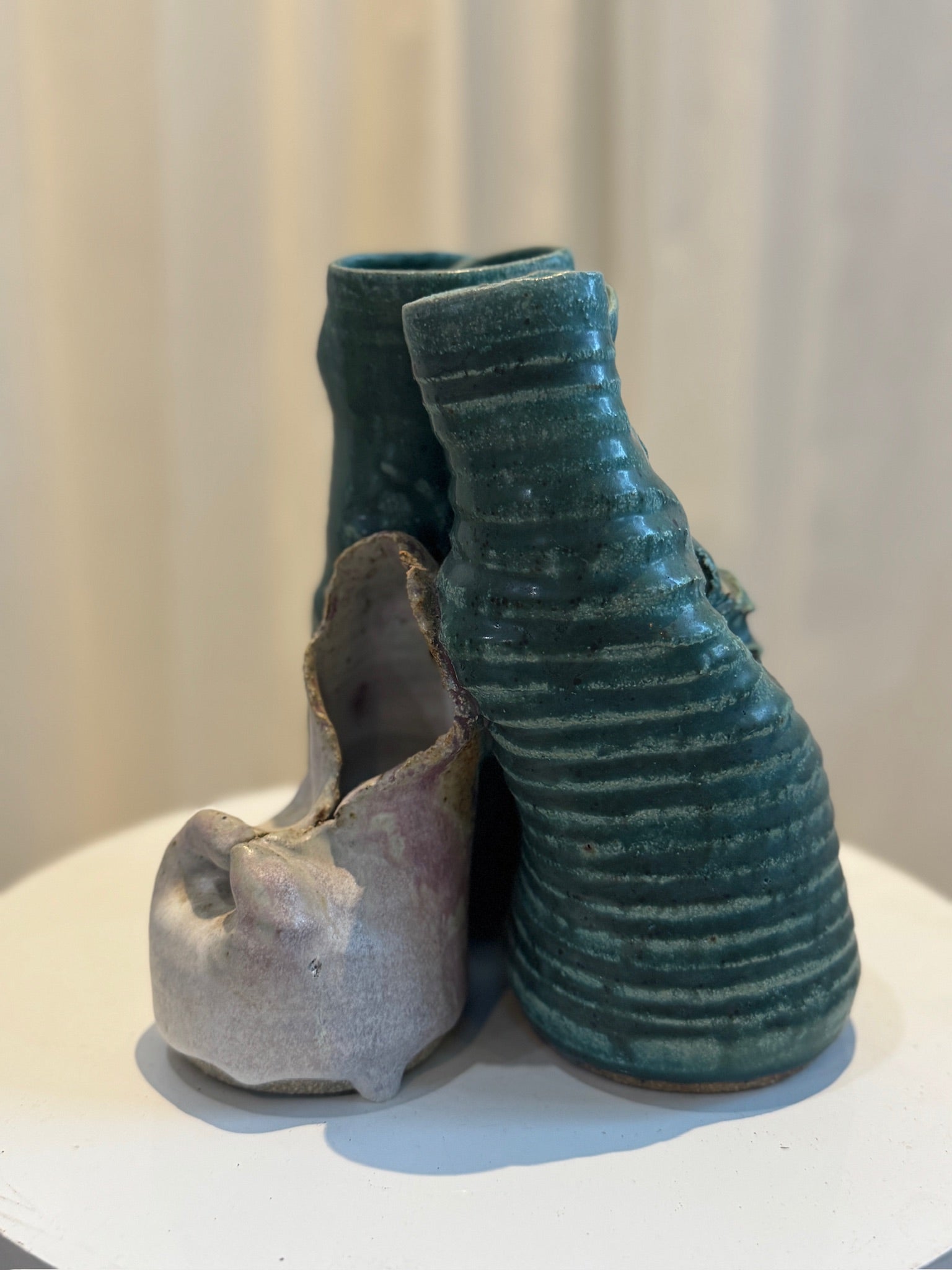 Abstract ceramic sculpture handcrafted with ribbed green glaze, matte off-white contrast, and organic trio composition, a statement art pottery piece — Hommes and Gardens, Pots + Planters Collection, Landscape Architect, Interior Designer, Outdoor Living, Art, Furniture, Objects, Best Gifts, Nature, Backyard, Yard, Outdoor Decorations, Home Decor, Home Design, Luxury Design.