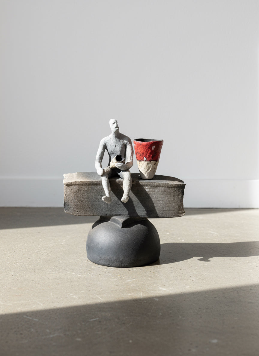 Abstract Modern Ceramic Sculpture – Human Figure with Red Vessel, showcasing balance and vibrant contrast. hommes + gardens estudio.