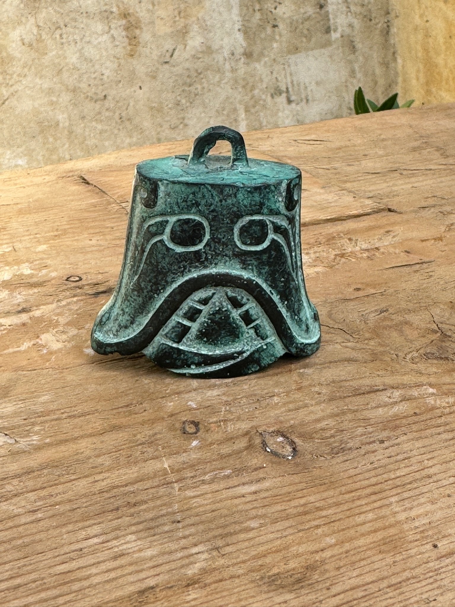 Shang Dynasty Bronze Bell featuring intricate mask engravings, showcasing ancient artistry. hommes + gardens estudio.