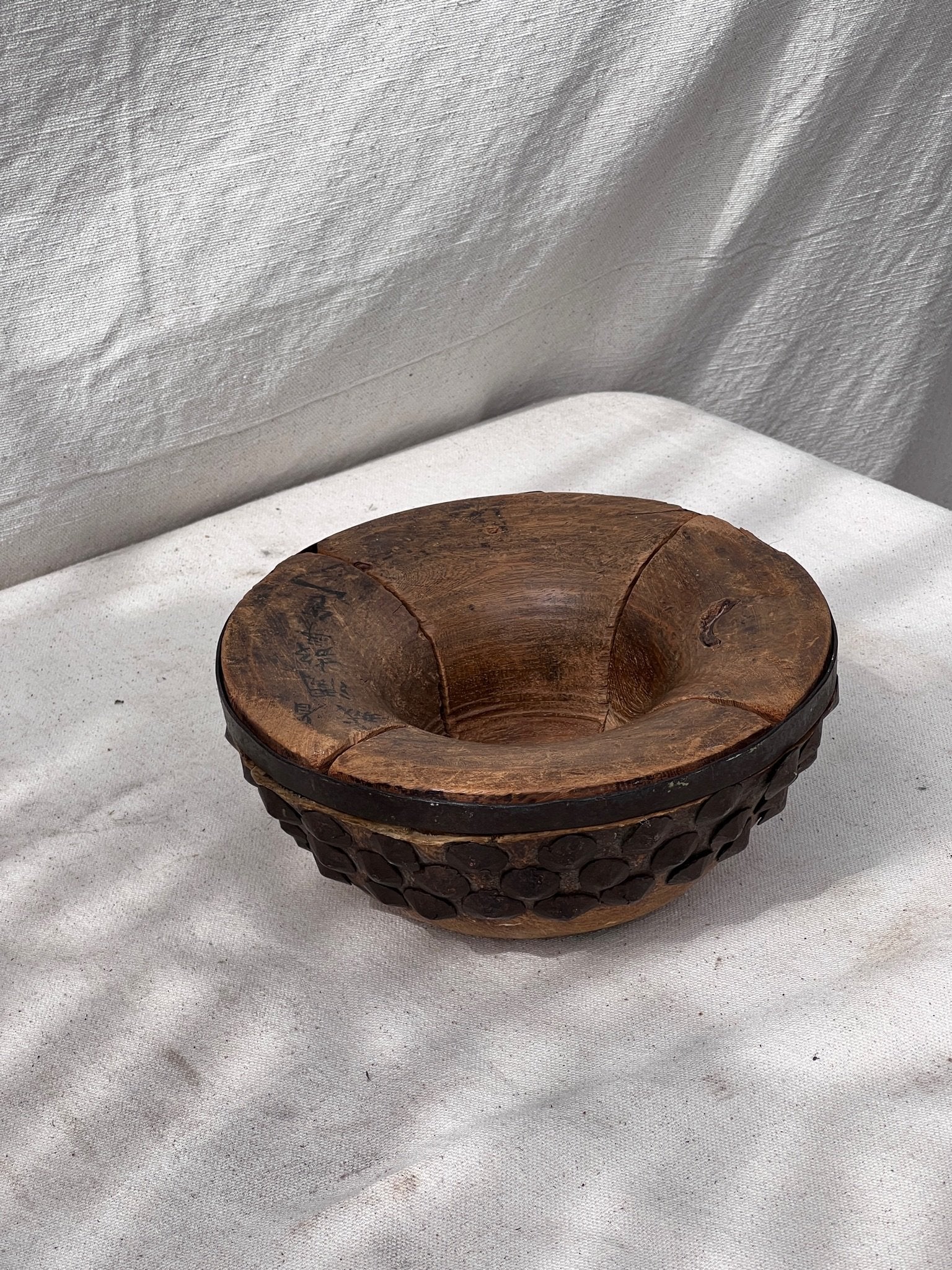 Primitive Chinese Wood & Animal Skin Bowl featuring intricate animal skin details and bolted metal accents. hommes + gardens estudio.