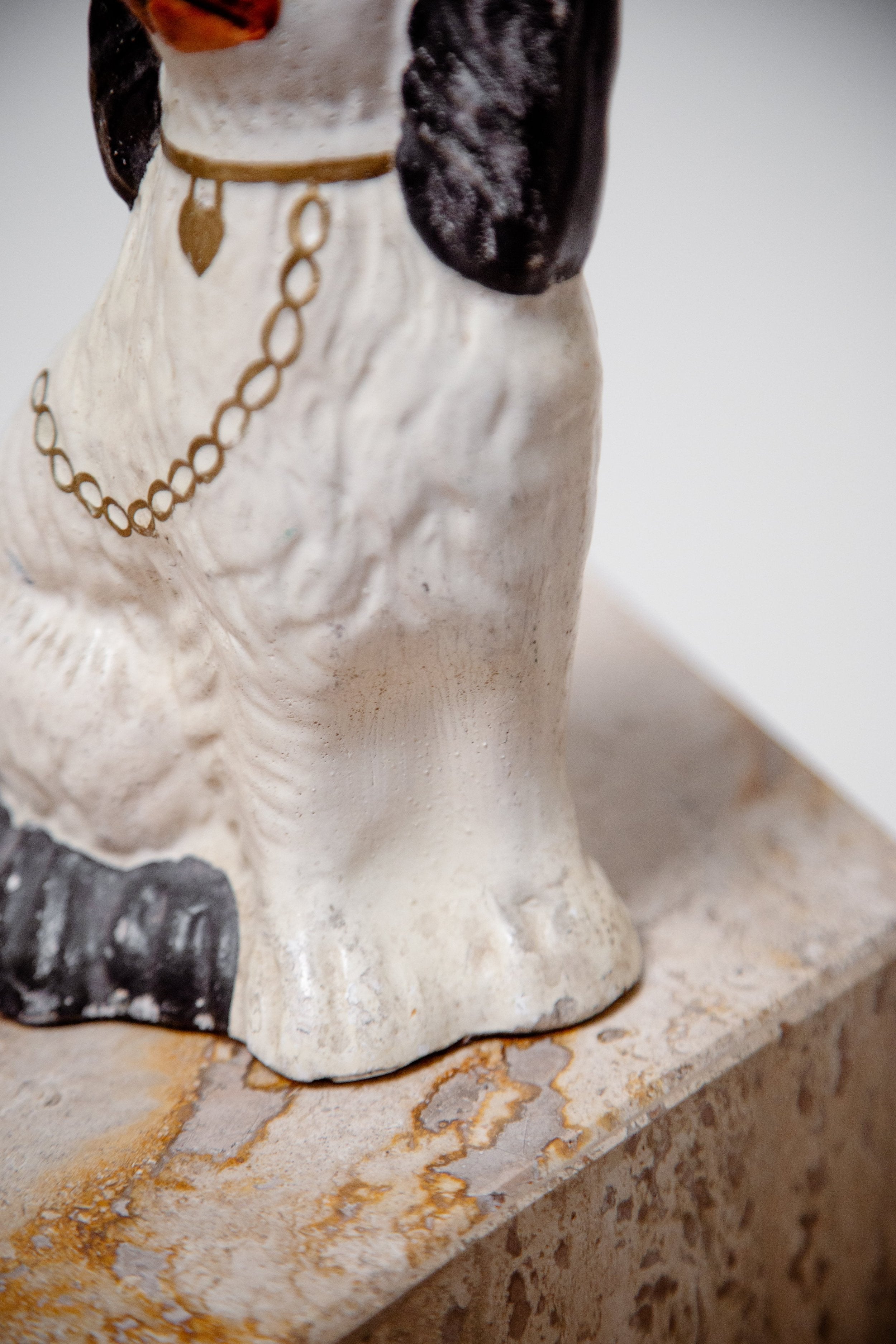 Close-up of a Victorian Pair of Staffordshire Dog Figurines on marble base, showcasing intricate details and craftsmanship. hommes + gardens estudio.