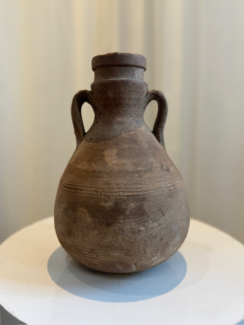 Antique terracotta amphora-style vessel with double handles, rounded body, and aged patina, inspired by Classical Roman pottery design — Hommes and Gardens, Vases + Vessels Collection, Landscape Architect, Interior Designer, Outdoor Living, Art, Furniture, Objects, Best Gifts, Nature, Backyard, Yard, Outdoor Decorations, Home Decor, Home Design, Luxury Design.