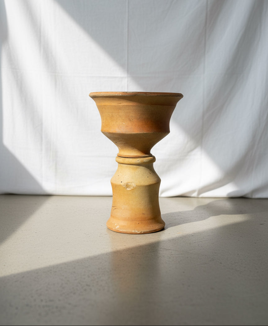 Antique two-piece terracotta hourglass vessel with sculptural rustic form and natural earthen texture, a handcrafted pottery piece embodying timeless artisanal charm — Hommes and Gardens, Pots + Vessels Collection, Home Decor, Landscape Architect, Interior Designer, Outdoor Living, Outdoor Decorations, Home Design, Luxury Design, Art, Furniture, Objects, Best Gifts, Nature, Backyard, Yard.