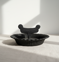 Antique Victorian Cast Iron Boot Scraper with Scalloped Tray on a neutral fabric background, hommes + gardens estudio.