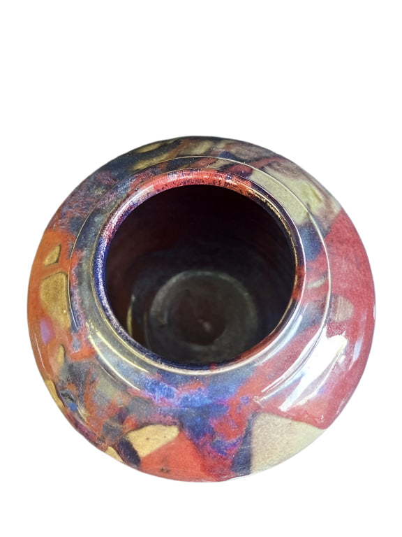 Top view of a signed glazed stoneware vase showcasing colorful abstract patterns and textures. hommes + gardens estudio.