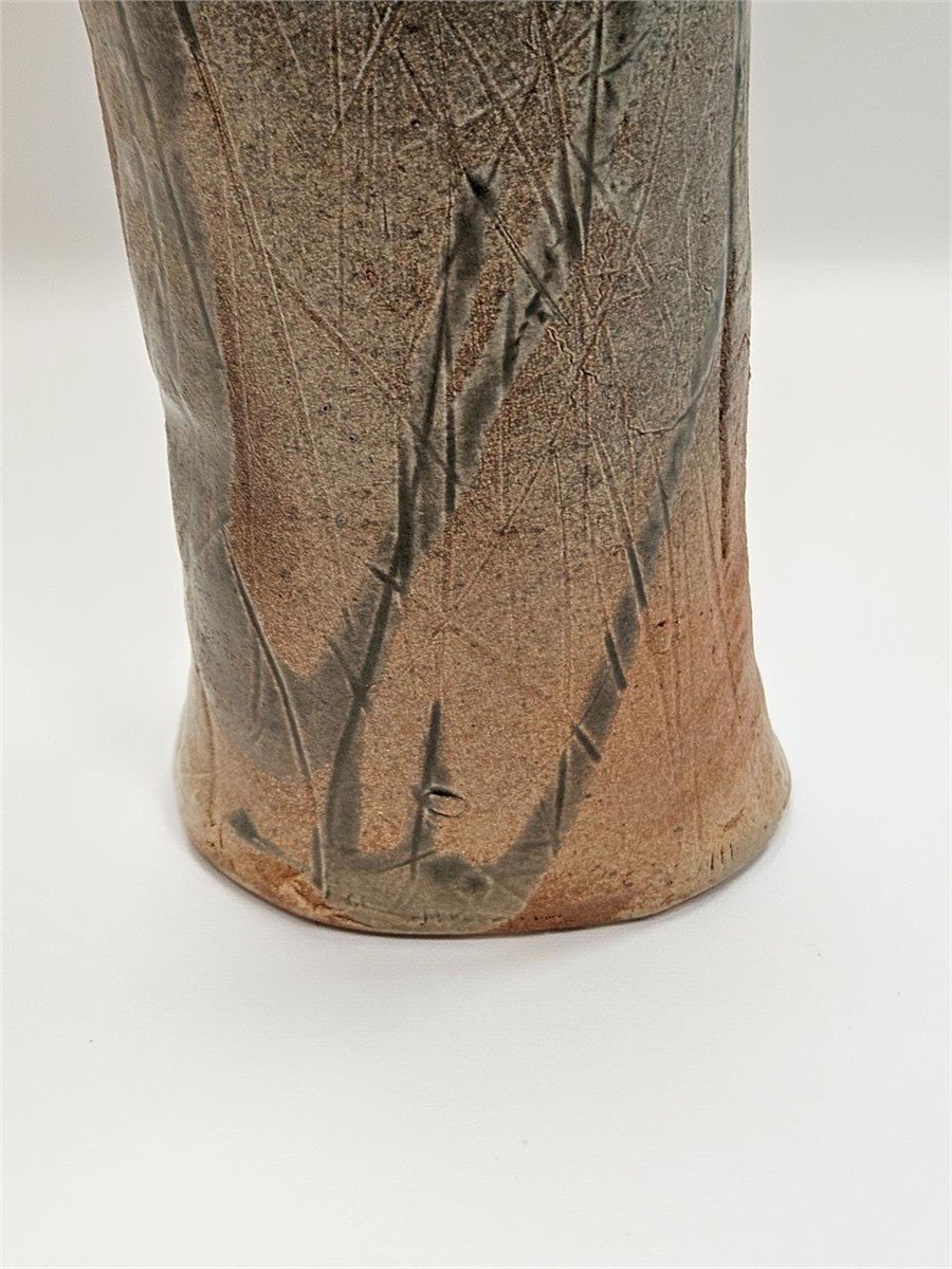 Close-up of a STUDIO POTTERY FREEFORM VASE SIGNED showcasing its unique shape and earthy texture, hommes + gardens estudio.