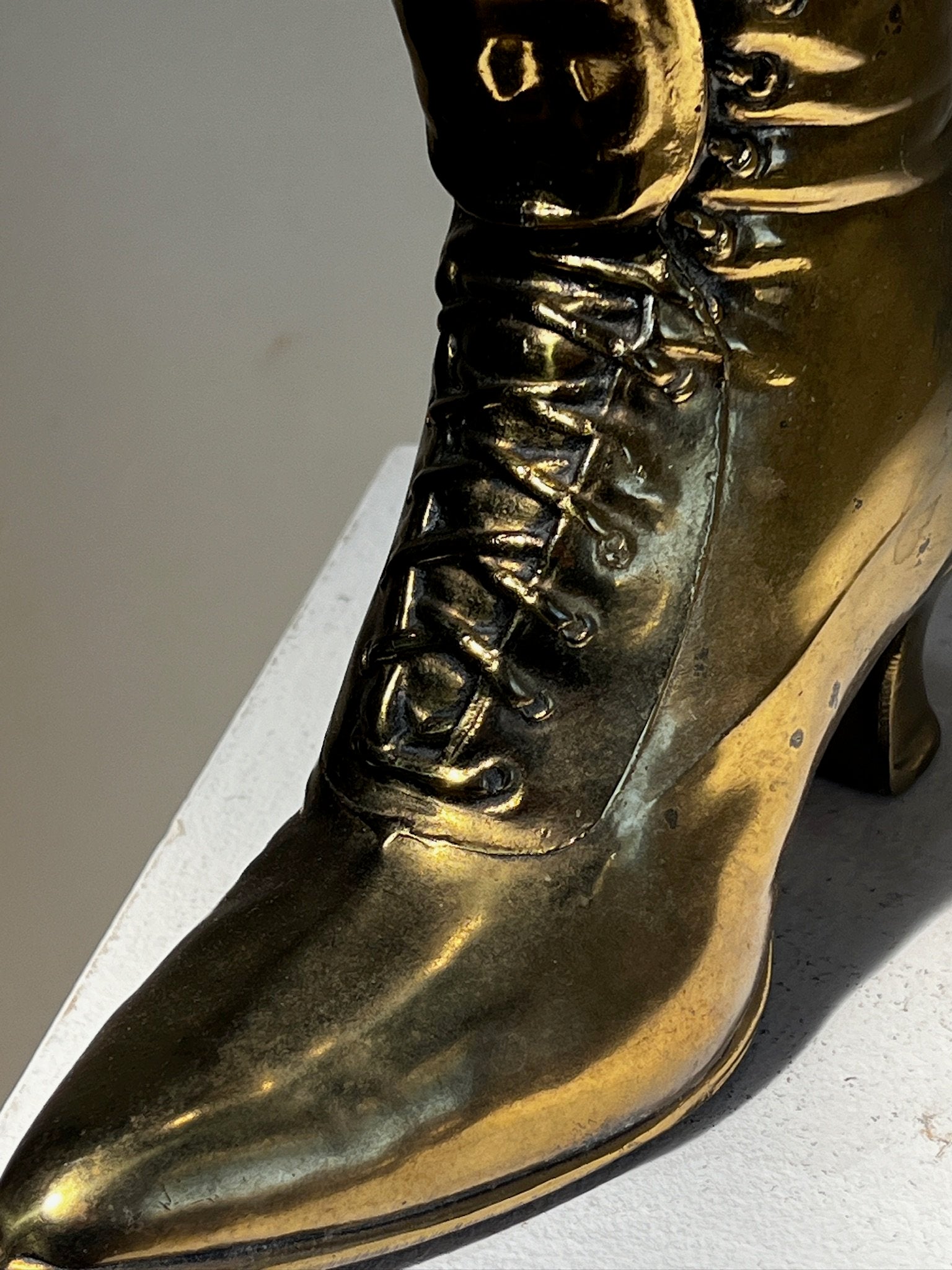 Vintage Victoria style cast brass boot window planter showcasing detailed craftsmanship and design. hommes + gardens estudio.