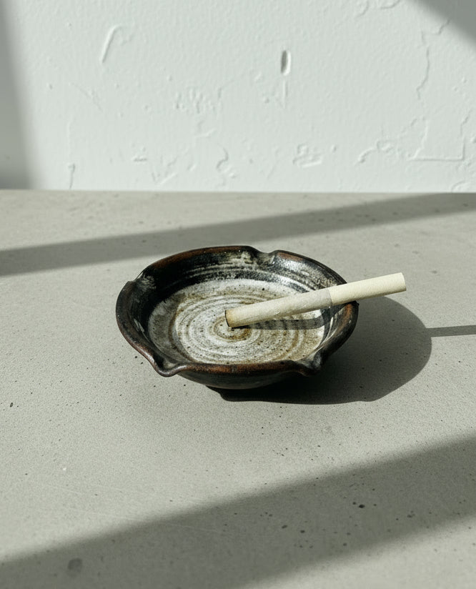 Signed Studio Pottery Ceramic Ashtray with Glazed Earth Tones – Handcrafted Artisan Work featuring a unique spiral design and notches. hommes + gardens estudio.