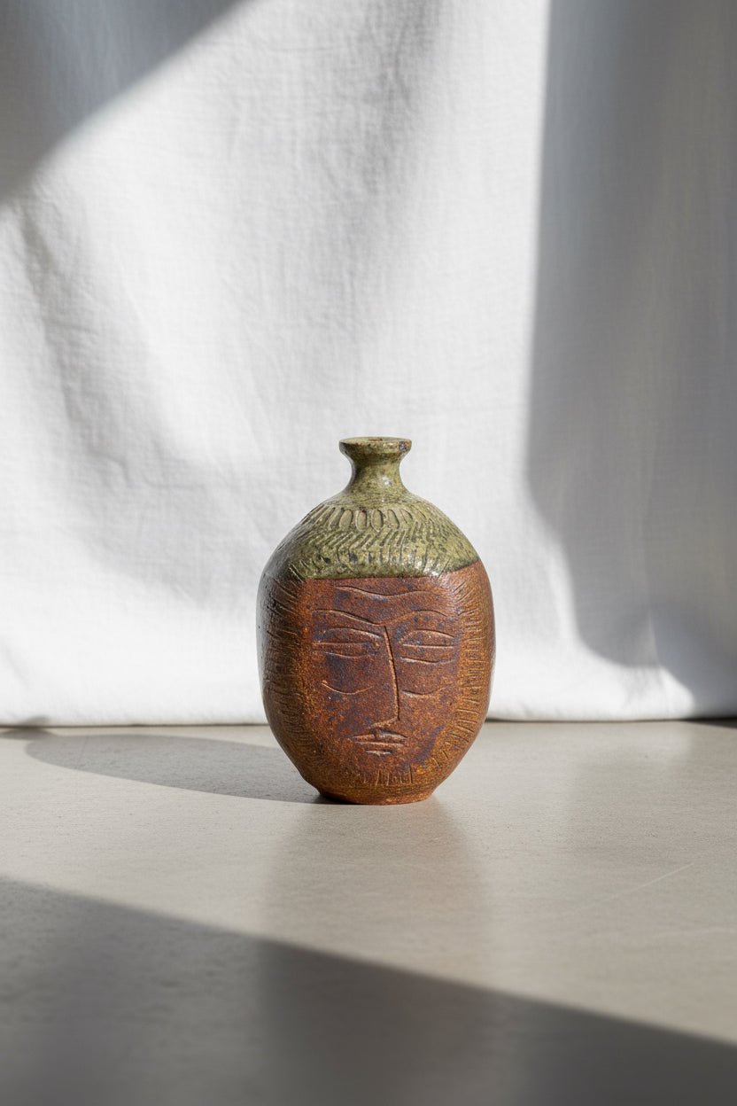 Ceramic stoneware bud vase by E. Harris featuring an engraved face design with earthy brown and beige tones, a unique handcrafted pottery piece blending art and function — Hommes and Gardens, Pots & Vessels Collection, Home Decor, Outdoor Decorations, Landscape Architect, Interior Designer, Outdoor Living, Home Design, Luxury Design, Art, Furniture, Objects, Best Gifts, Nature, Backyard, Yard.
