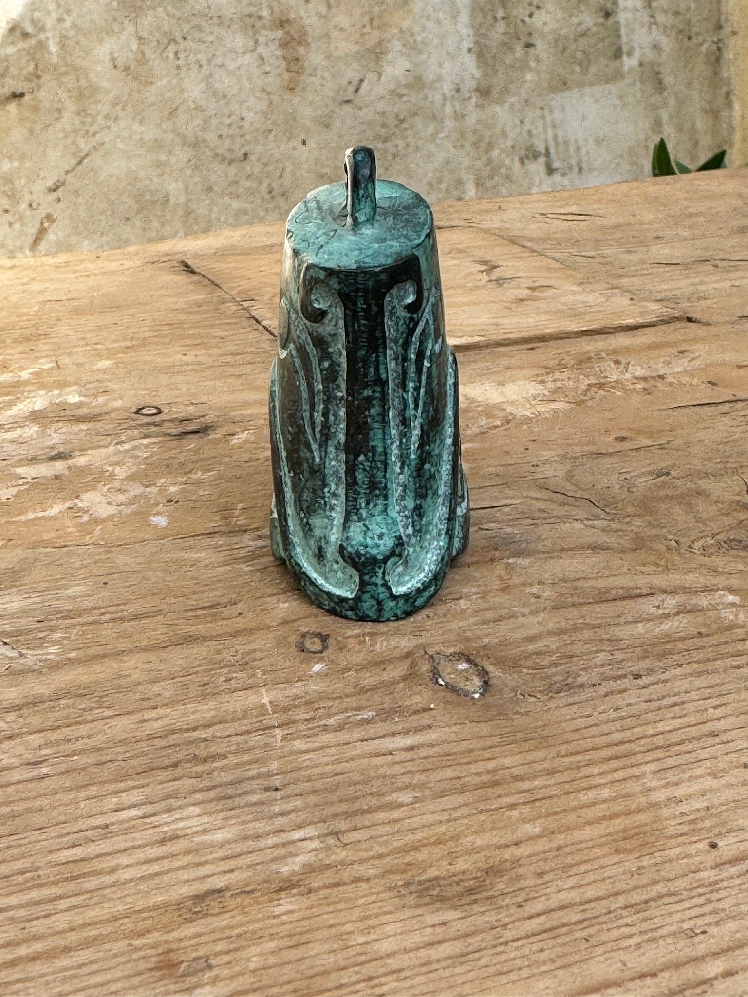 Shang Dynasty Bronze Bell featuring intricate mask engravings, symbolic of ancient Chinese artistry. hommes + gardens estudio.