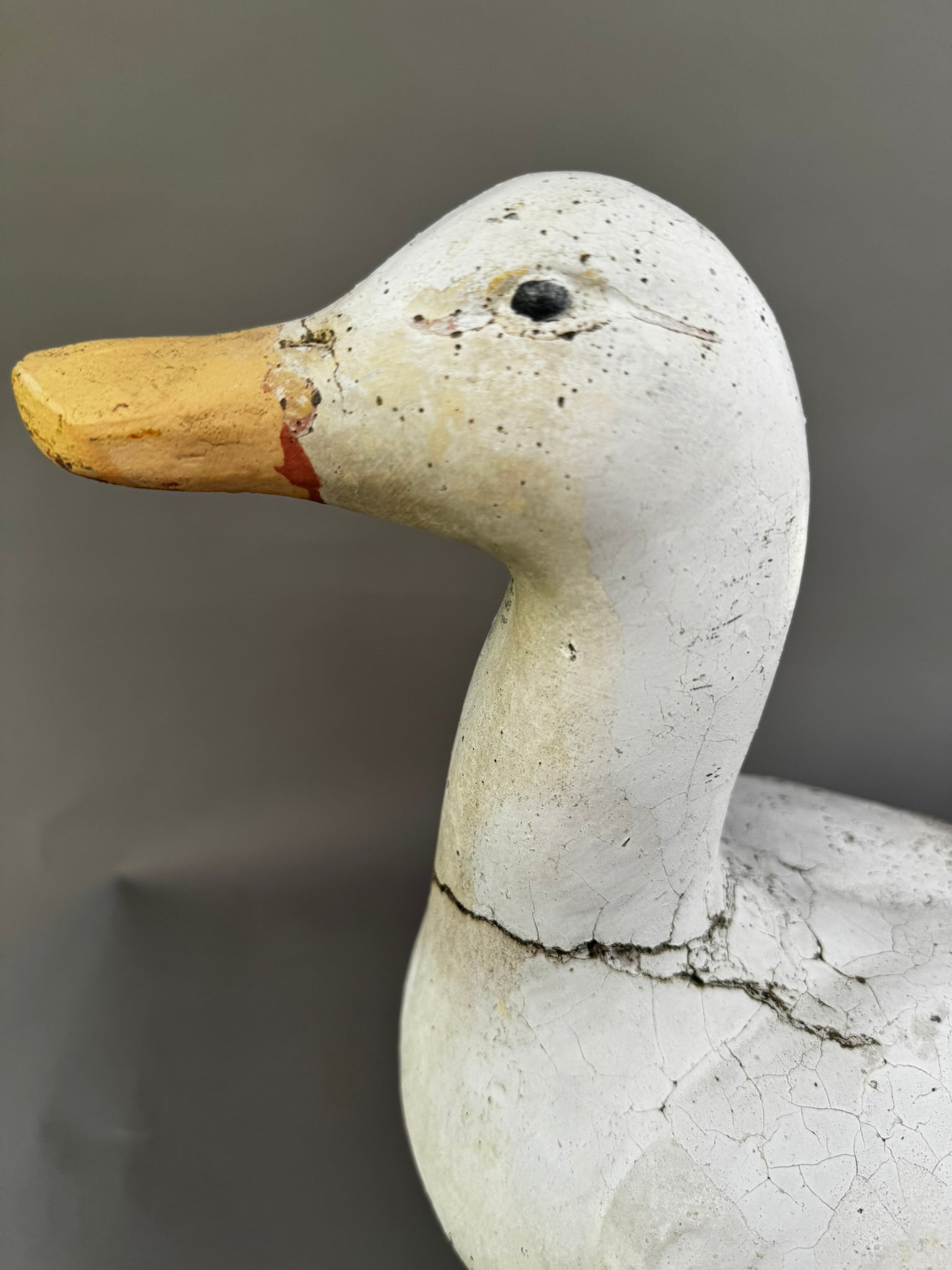 Vintage Handcrafted Concrete Duck Garden Sculpture – Rustic Outdoor Decor, close-up view of duck's head and beak, hommes + gardens estudio.