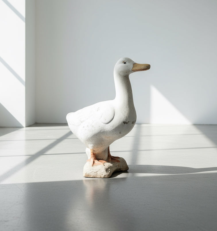 Vintage Handcrafted Concrete Duck Garden Sculpture – Rustic Outdoor Decor displayed in bright interior setting. hommes + gardens estudio.