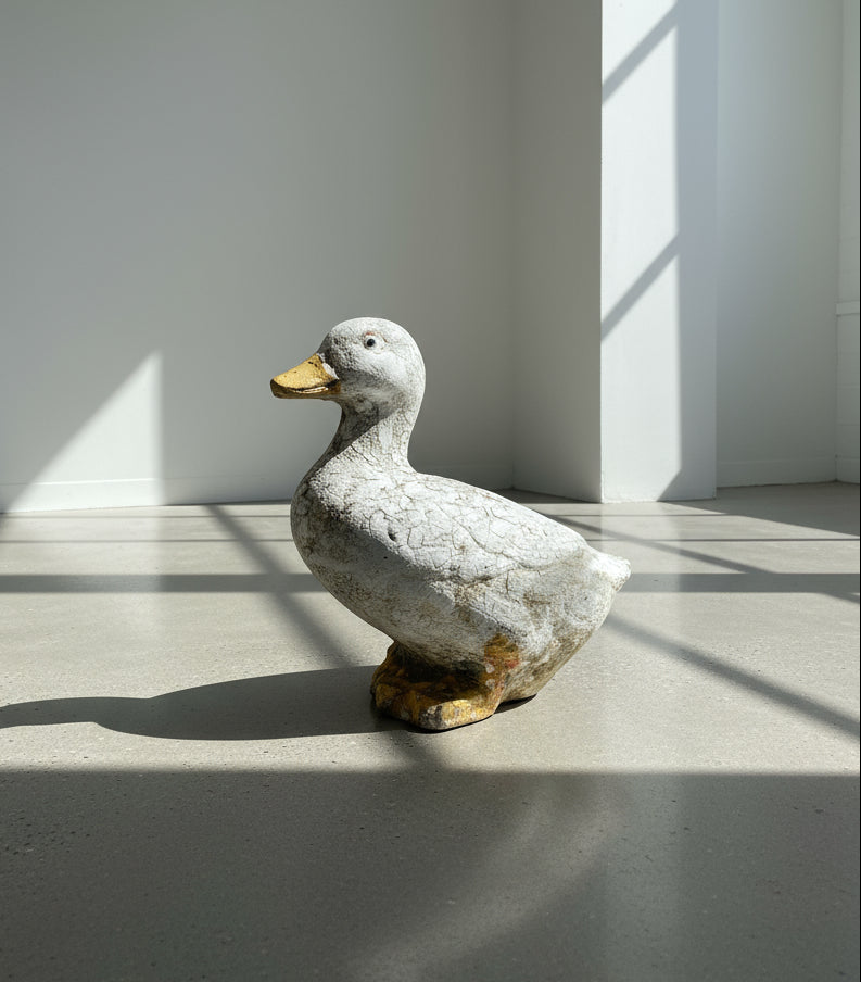 Weathered Vintage Concrete Duck Garden Sculpture – Rustic Folk Art Décor displayed indoors, showcasing its charming details. hommes + gardens estudio.