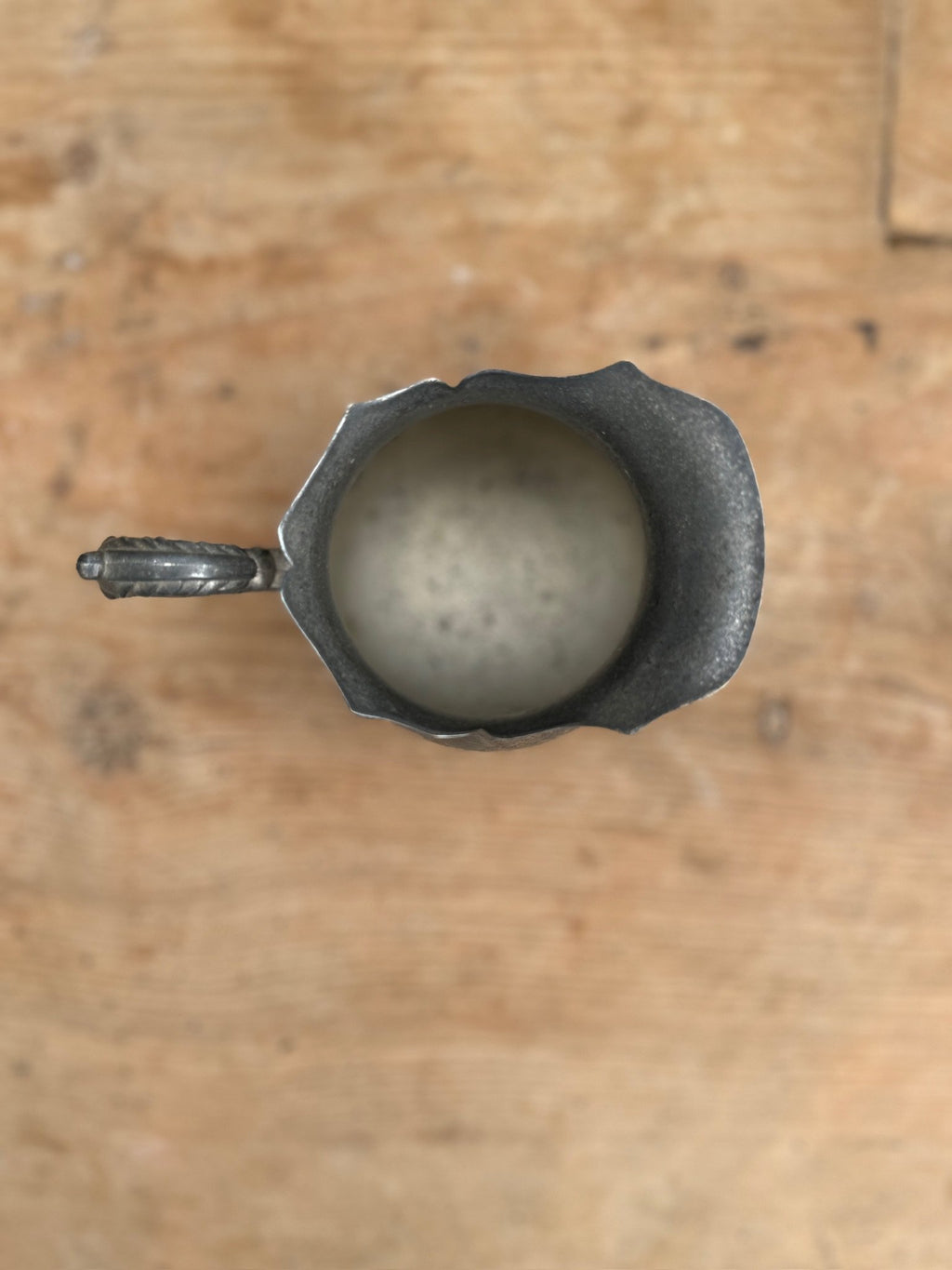 Vintage Silver-Plated Footed Creamer with Handle viewed from above, showcasing its elegant design and handle. hommes + gardens estudio.