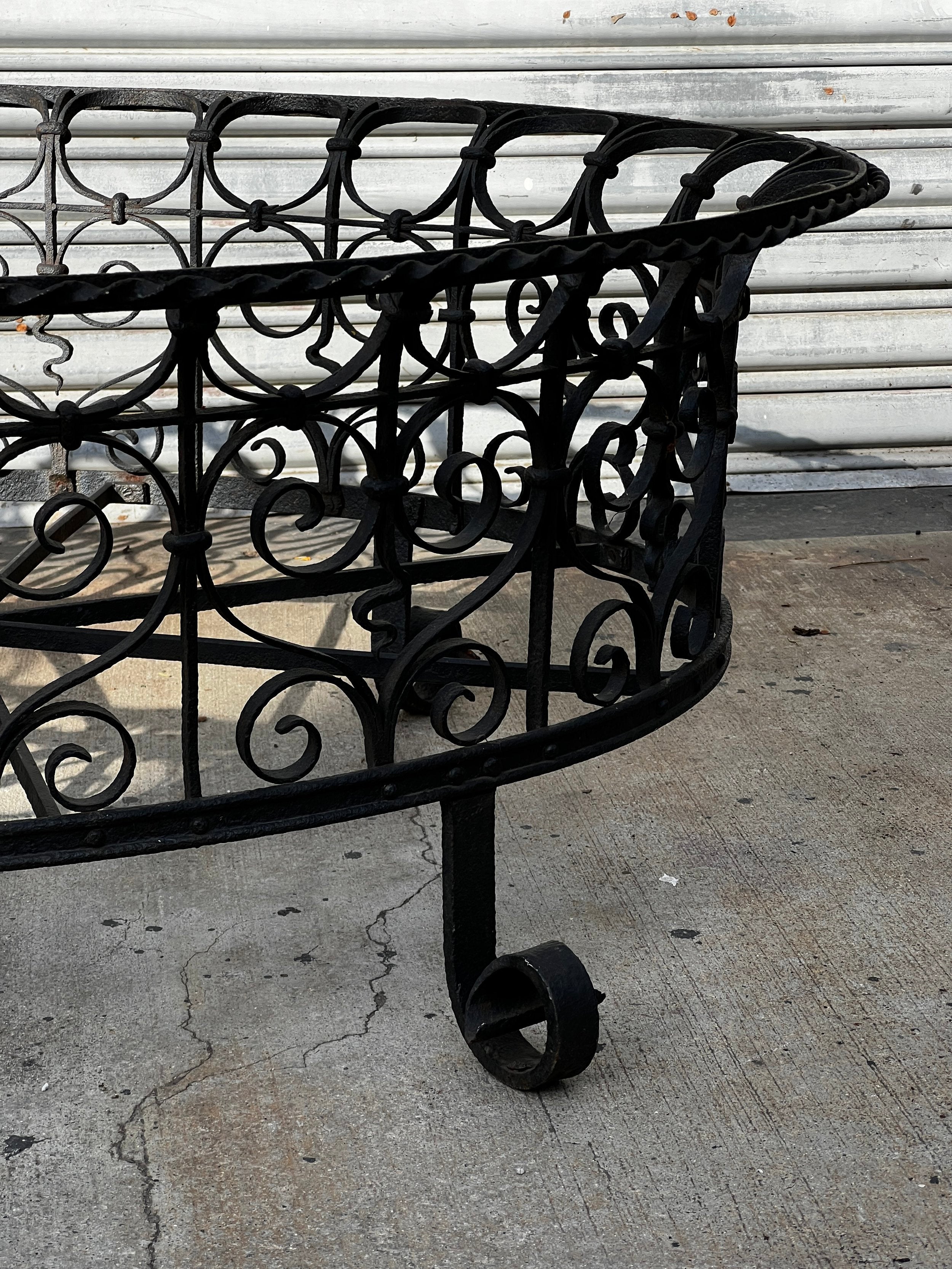 Victorian Oval Wrought Iron Plant Holder featuring intricate scrollwork and a classic design. hommes + gardens estudio.