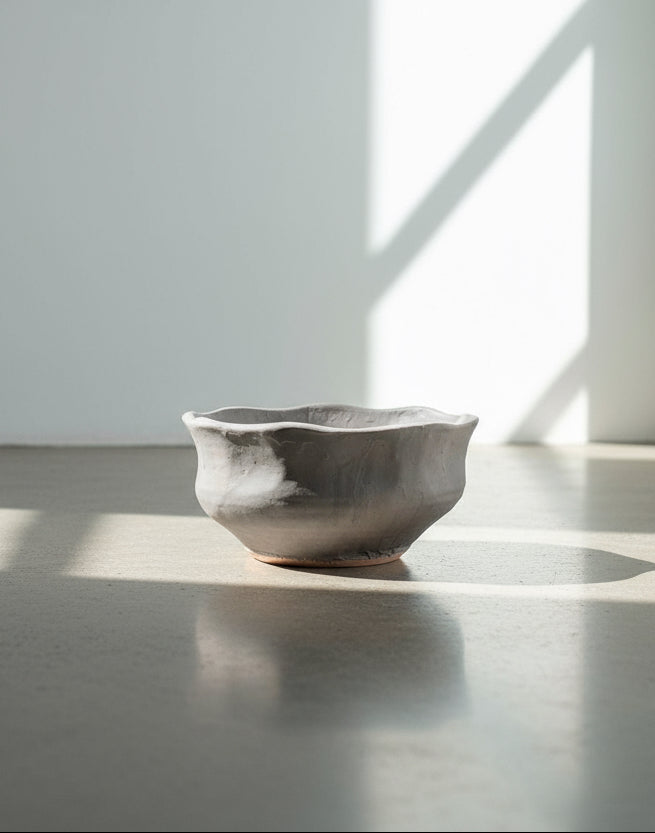 Signed gray clay bowl with artistic irregular rim and painted finish, a handcrafted pottery piece combining rustic charm with modern sophistication — Hommes and Gardens, Catchall Collection, Home Decor, Outdoor Decorations, Landscape Architect, Interior Designer, Outdoor Living, Home Design, Luxury Design, Art, Furniture, Objects, Best Gifts, Nature, Backyard, Yard.