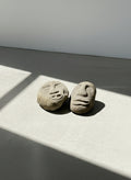 Pair of hand-carved stone tribal face sculptures with expressive primitive features, ideal for garden or interior display — Hommes and Gardens, home decor, garden decor, outdoor decorations, home design, luxury design, Landscape Architect, Interior Designer, Outdoor Living, Art, Furniture, Objects, Best Gifts, Nature, Backyard, Yard.