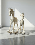 Antique Hand-Carved Wooden Rocking Horses – Rustic Folk Art Pair, 23” & 15.5” displayed in a bright room. hommes + gardens estudio.