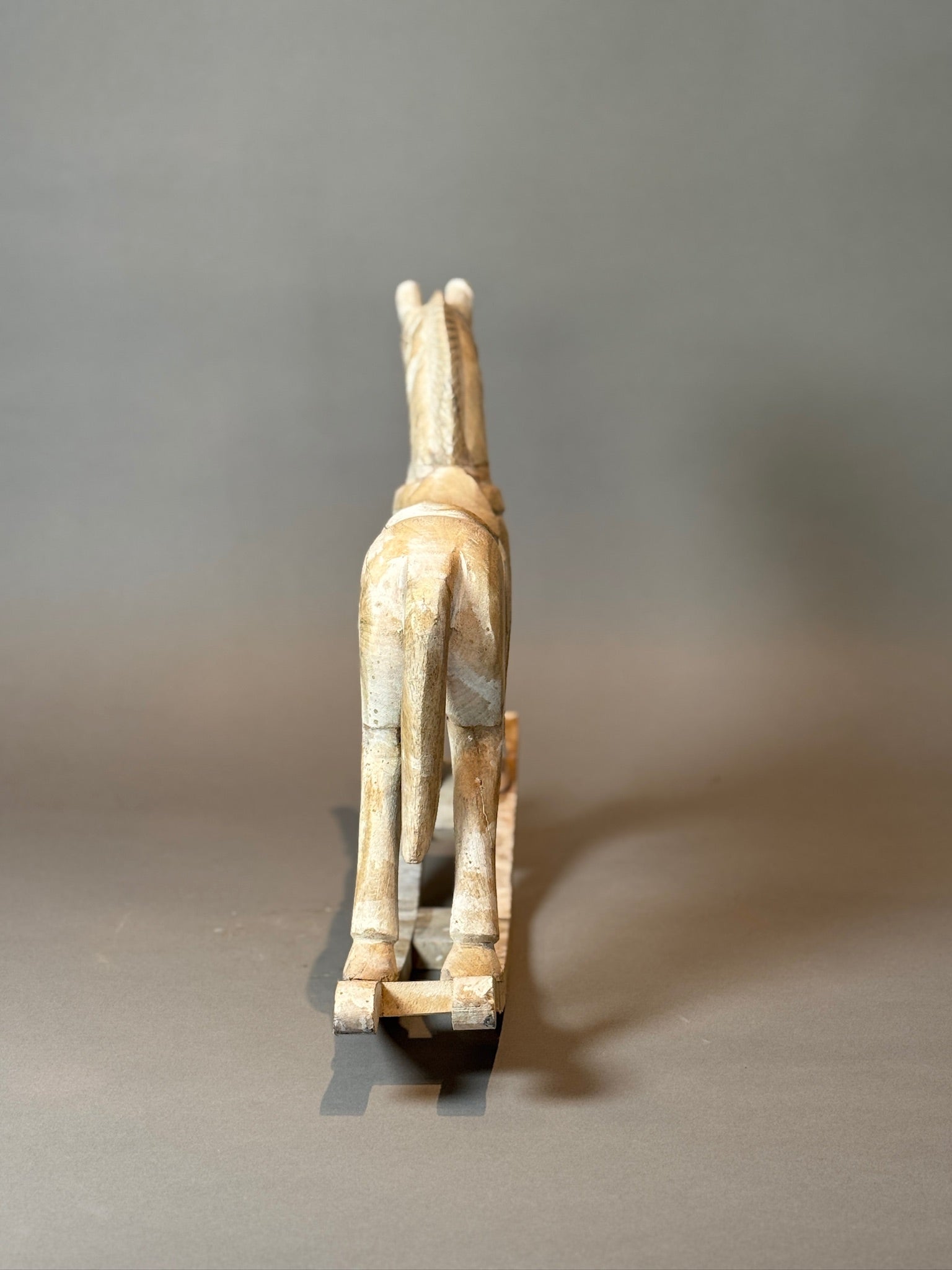 Antique Hand-Carved Wooden Rocking Horses – Rustic Folk Art Pair, 23” & 15.5” showcased from behind, displaying detailed craftsmanship, hommes + gardens estudio.