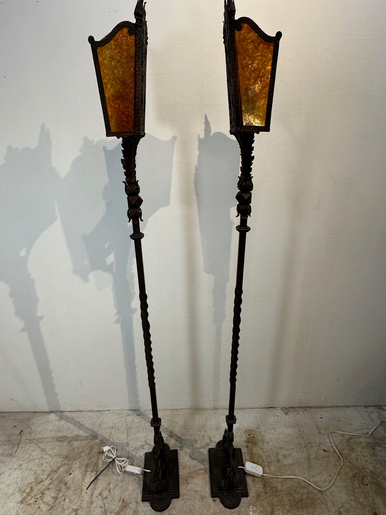 Hand-forged iron floor lamps with amber mica shades, vintage pair with elegant design and warm light for classic interiors — Hommes and Gardens, Lights + Lanterns Collection, Landscape Architect, Interior Designer, Outdoor Living, Art, Furniture, Objects, Best Gifts, Nature, Backyard, Yard, Outdoor Decorations, Home Decor, Home Design, Luxury Design.