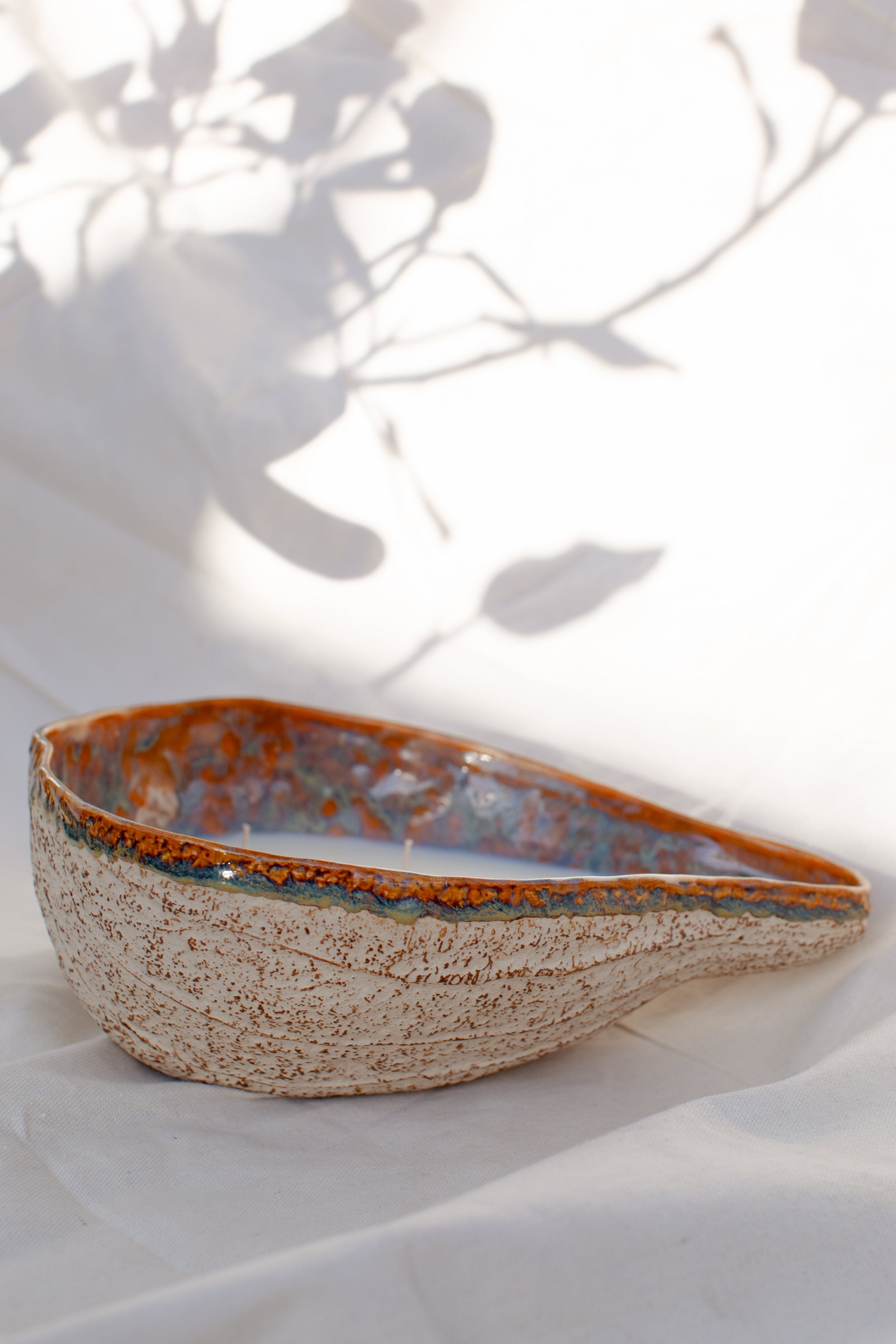 Handmade Ceramic Glazed Bowl | H&G x Western Disco displayed against a soft background with shadowy outlines. hommes + gardens estudio.