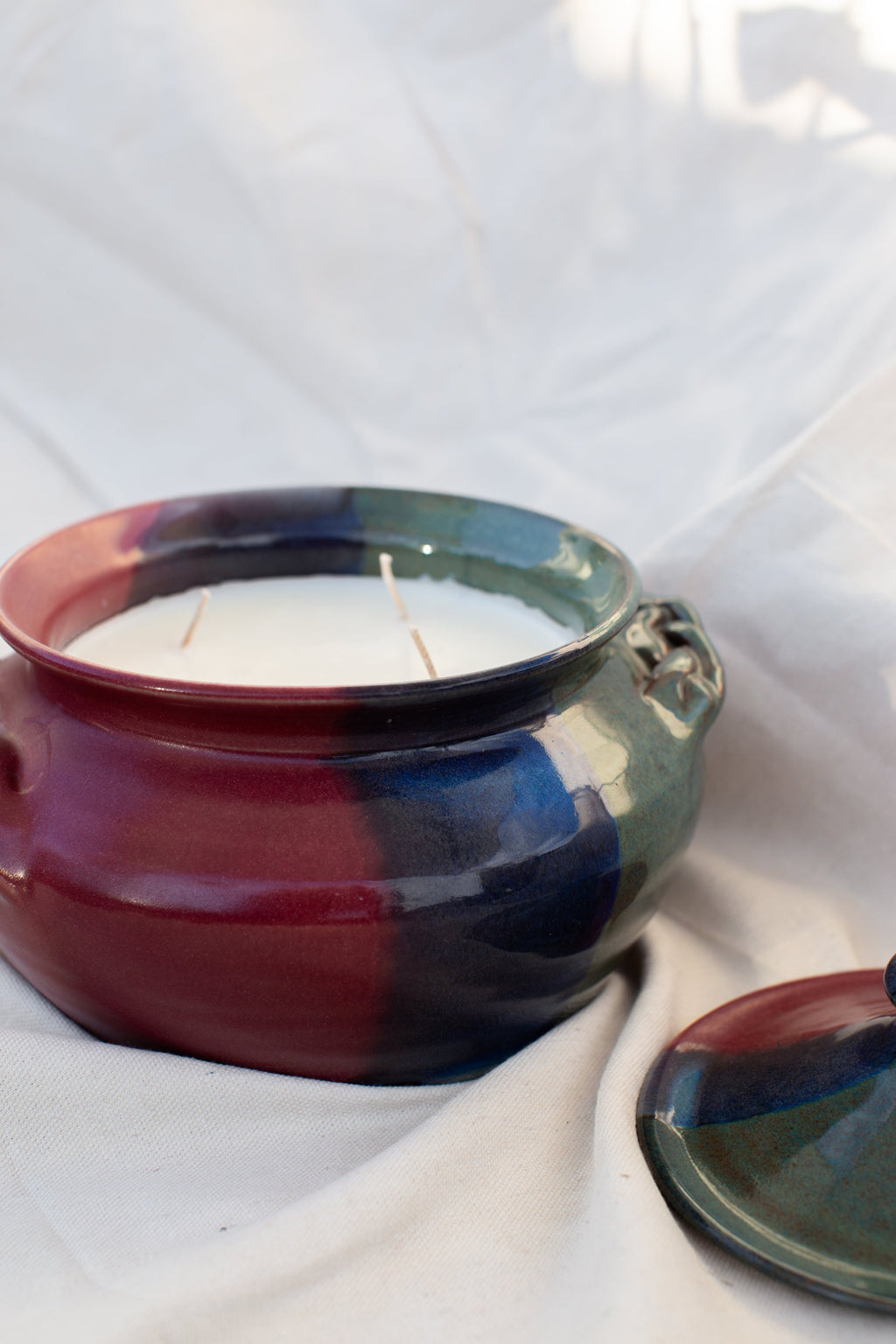 Vintage Ceramic Lidded Dish | H&G x Western Disco displayed on fabric background, featuring multi-colored glaze and three wicks, hommes + gardens estudio.