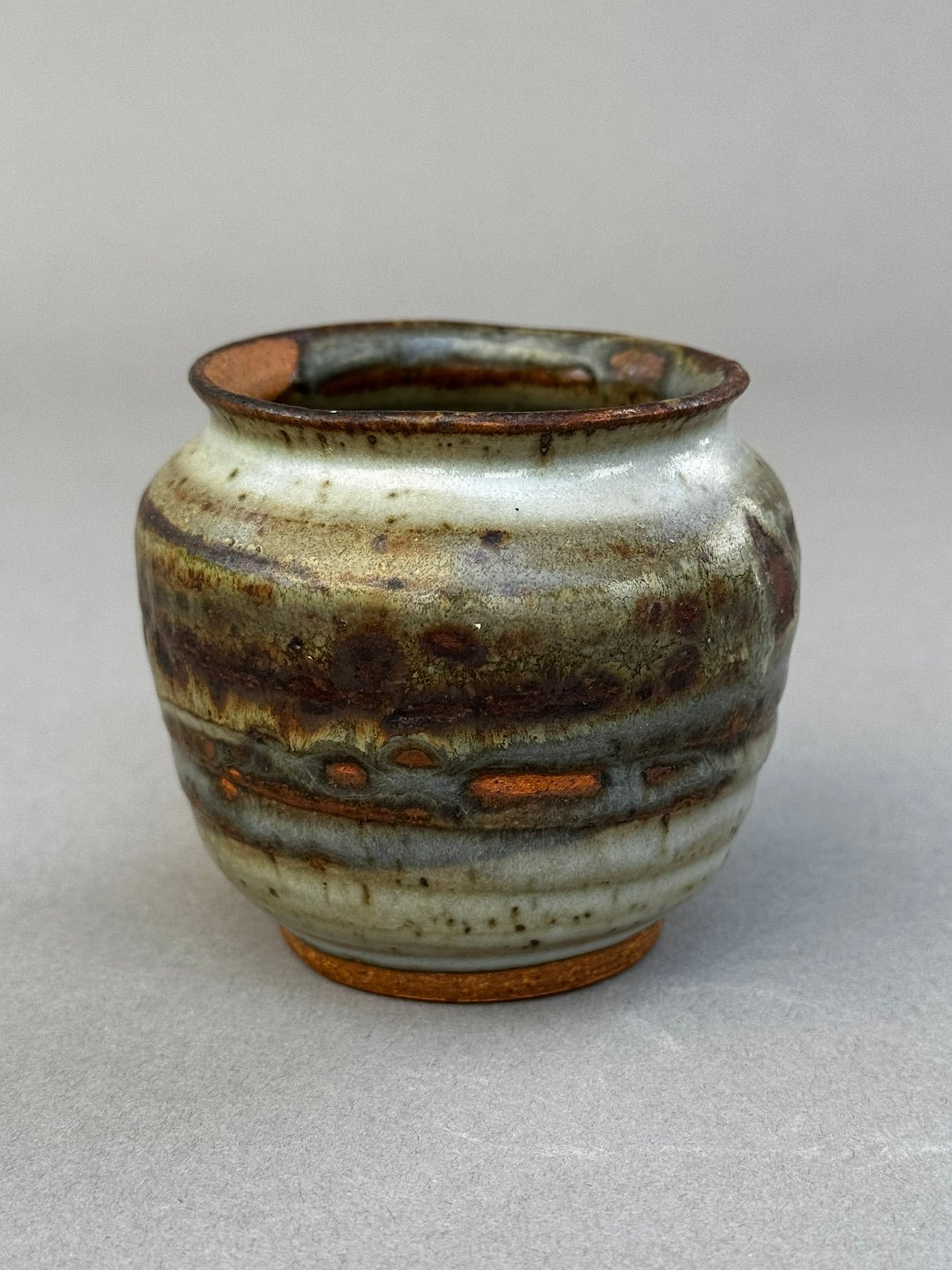 Hand-thrown ceramic urn vase signed P.S.E. with layered ash glaze in brown, gray, and terracotta tones, organic studio pottery design — Hommes and Gardens, Home Decor Collection, landscape design, plant design, Landscape Architect, Interior Designer, Outdoor Living, Outdoor Decorations, Home Design, Luxury Design, Art, Furniture, Objects, Best Gifts, Nature, Backyard, Yard.