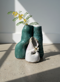 Handcrafted ceramic sculpture featuring interconnected organic forms with contrasting green and off-white glazes, an abstract textural art piece showcasing contemporary craftsmanship — Hommes and Gardens, Pots + Vessels Collection, Home Decor, Landscape Architect, Interior Designer, Outdoor Living, Outdoor Decorations, Home Design, Luxury Design, Art, Furniture, Objects, Best Gifts, Nature, Backyard, Yard.