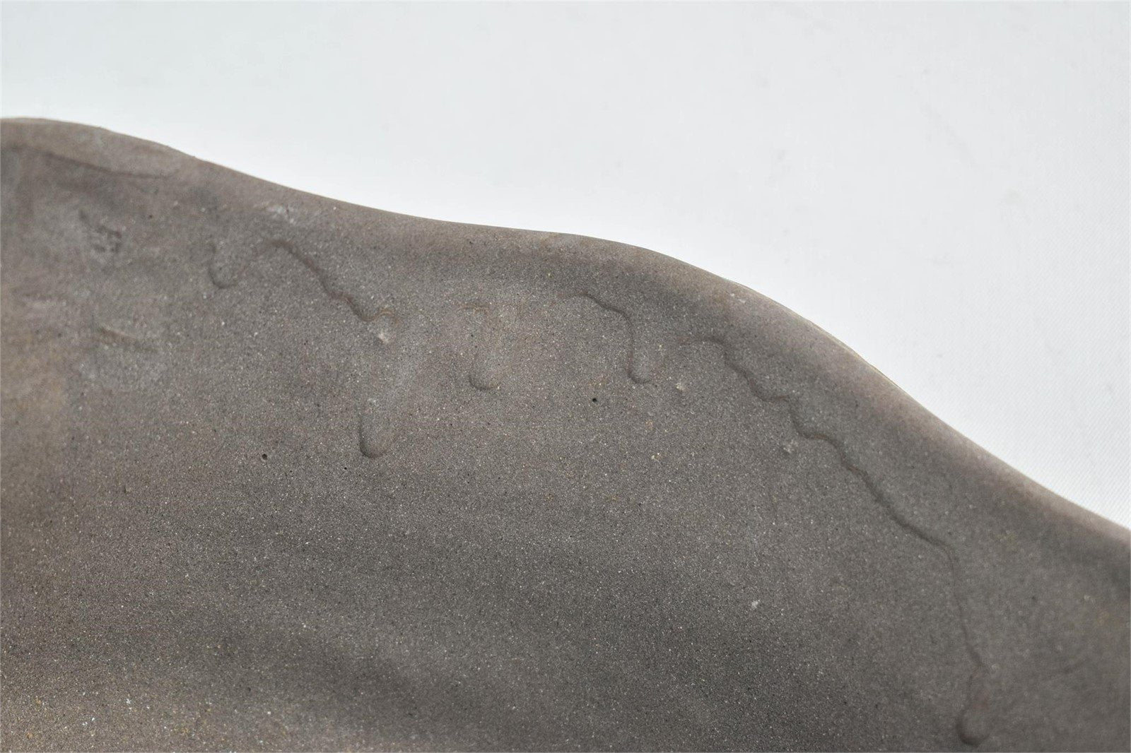 Handcrafted gray clay bowl featuring a rustic yet refined painted surface, signed by the artist, ideal for decorative or functional use — Hommes and Gardens, Catchall Collection, home decor, outdoor decorations, home design, luxury design, Landscape Architect, Interior Designer, Outdoor Living, Art, Furniture, Objects, Best Gifts, Nature, Backyard, Yard.